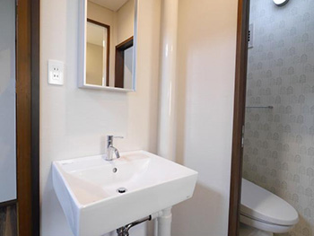 大山崎町の中古マンションリフォーム。リフォーム後の洗面室。サンワカンパニーの洗面台と鏡です。お施主様支給で、ライオンホームで取り付けました。